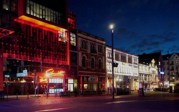 Reeperbahn nightlife scene in Hamburg with illuminated buildings and neon signs.