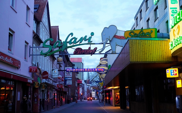 Reeperbahn nightlife street with neon signs in Hamburg's St. Pauli district.