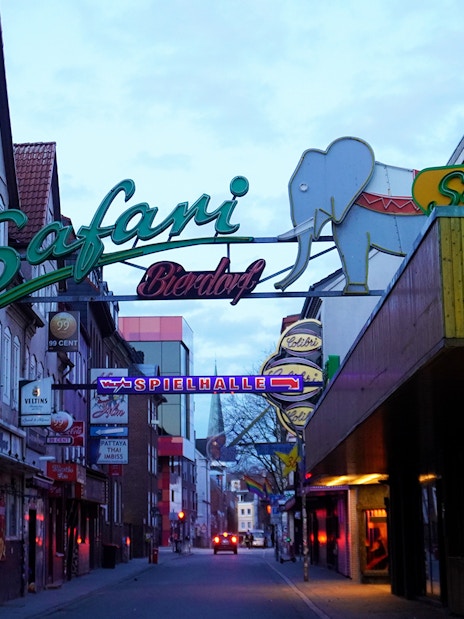 Reeperbahn nightlife street with neon signs in Hamburg's St. Pauli district.
