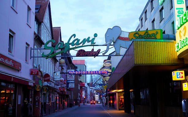 Reeperbahn nightlife street with neon signs in Hamburg's St. Pauli district.
