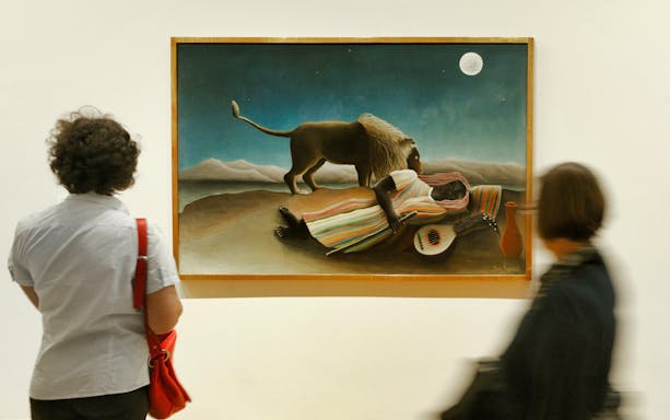 Visitors viewing "The Sleeping Gypsy" painting at a New York museum.