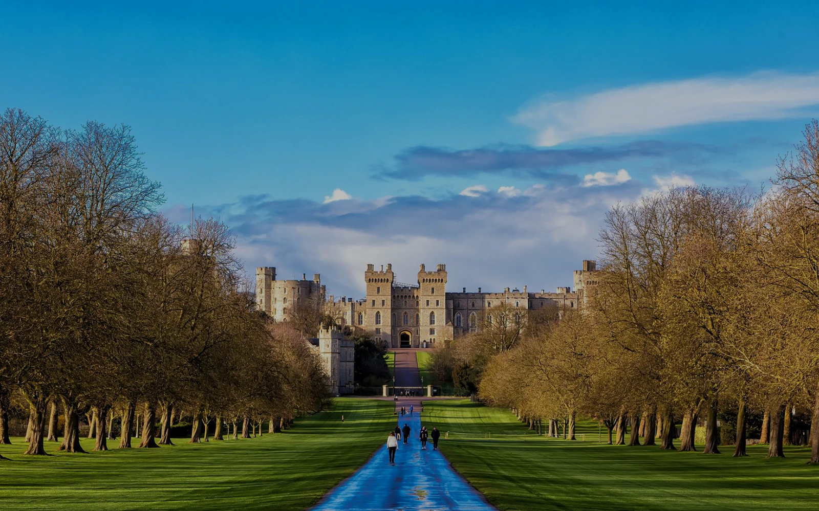 Windsor Castle view with visitors walking along the Long Walk path.