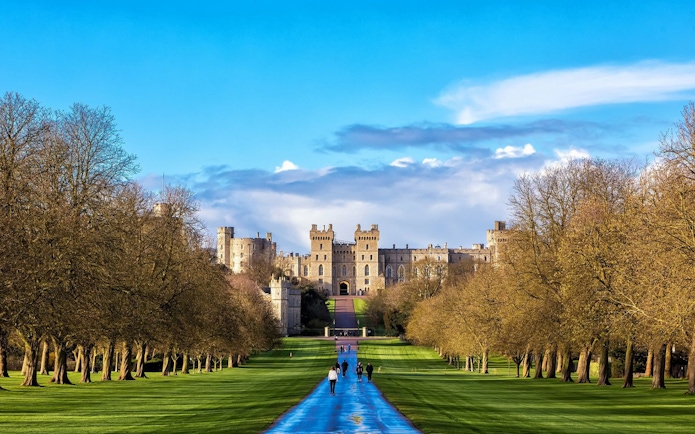 Windsor Castle view with visitors walking along the Long Walk path.
