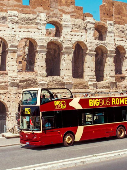 Open-top tour bus in front of the Colosseum, Rome.