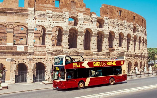 Hop-on hop-off bus in front of the Colosseum, Rome.