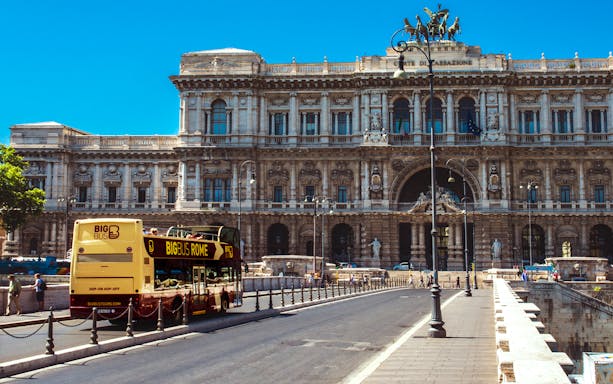 Big Bus tour passing by the Palace of Justice in Rome.