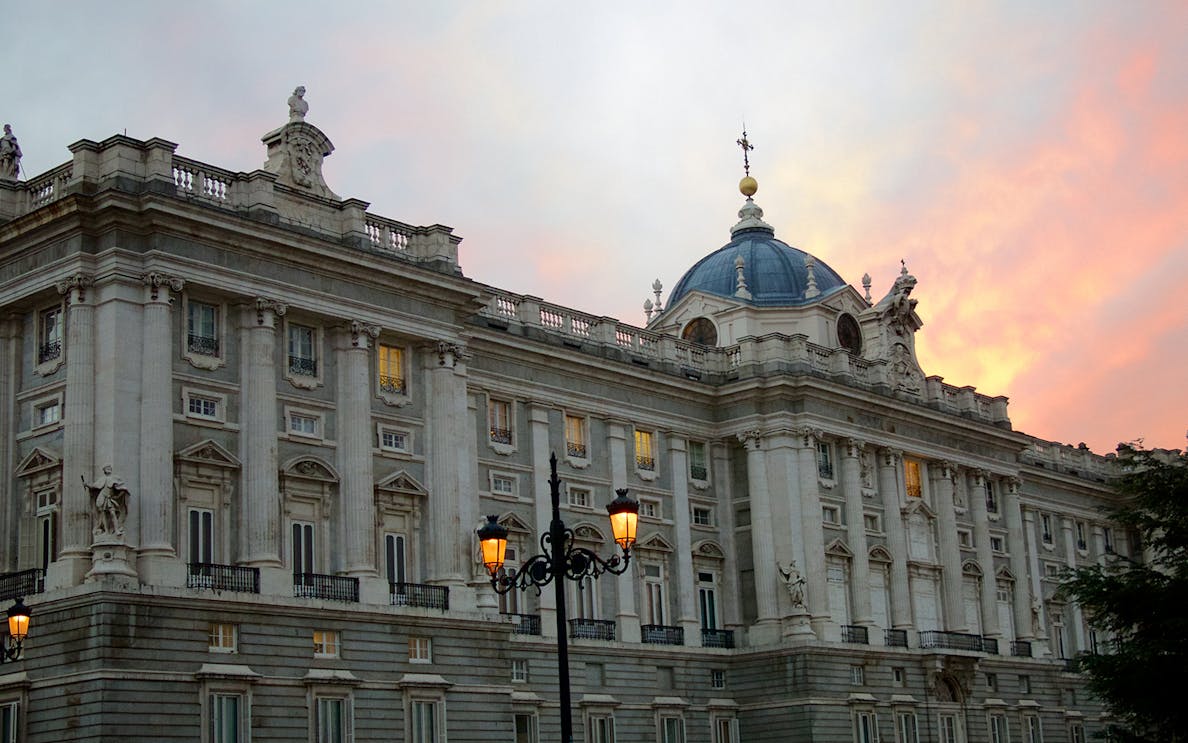 Royal Palace of Madrid exterior at sunset during guided tour.