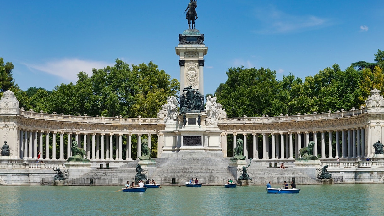 Boats on the lake in front of the Alfonso XII monument in El Retiro Park, Madrid.