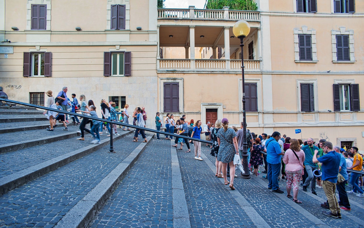 Tourists walking up steps near Vatican Museums entrance, Rome.