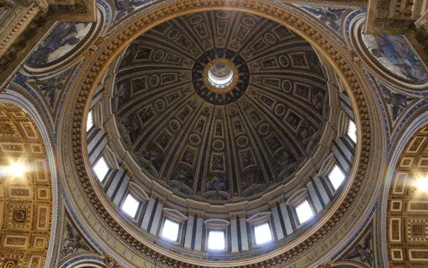 Dome interior of St. Peter’s Basilica, Vatican City, showcasing intricate artwork and architecture.