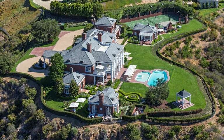 Aerial view of a luxury estate with a pool and tennis court in Hollywood Hills.