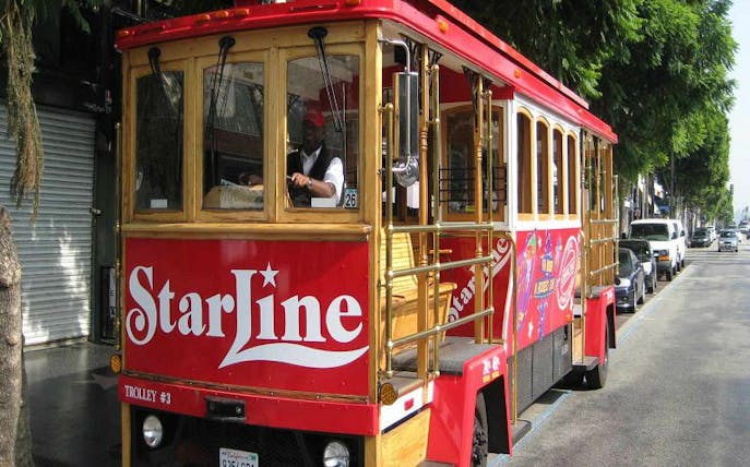 Red trolley on Hollywood street for StarLine tour.