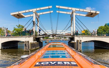 Cruise boat passing under the Skinny Bridge in Amsterdam.