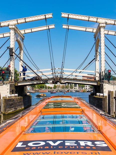 Cruise boat passing under the Skinny Bridge in Amsterdam.