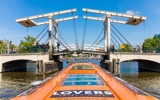 Cruise boat passing under the Skinny Bridge in Amsterdam.