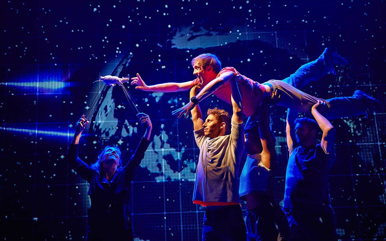 Actors performing a scene from "The Curious Incident of the Dog in the Night-Time" on stage.