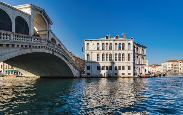 Rialto Bridge and canal view on a gondola ride in Venice.