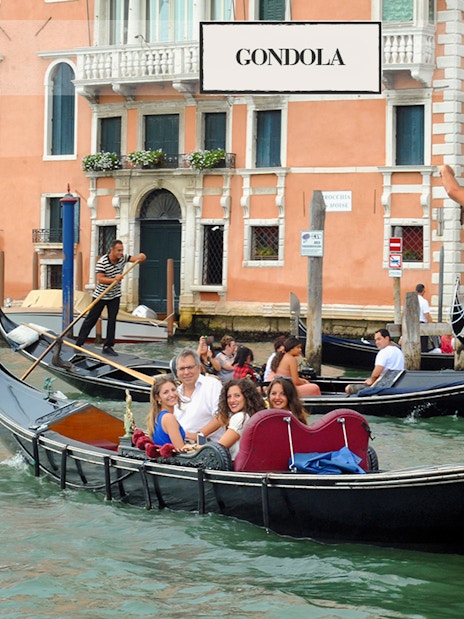 Gondola ride on a canal in Venice with tourists and gondoliers.