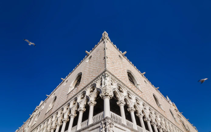 Doge's Palace facade in Venice under clear blue sky.