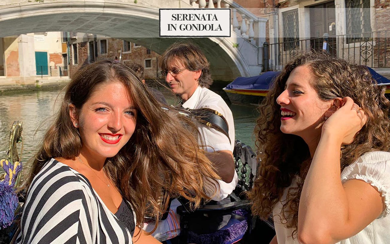 Gondola ride with musician serenading passengers on Venice canal.