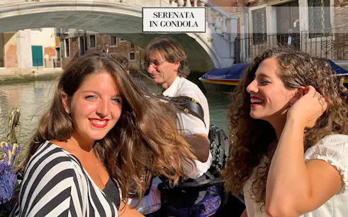 Gondola ride with musician serenading passengers on Venice canal.