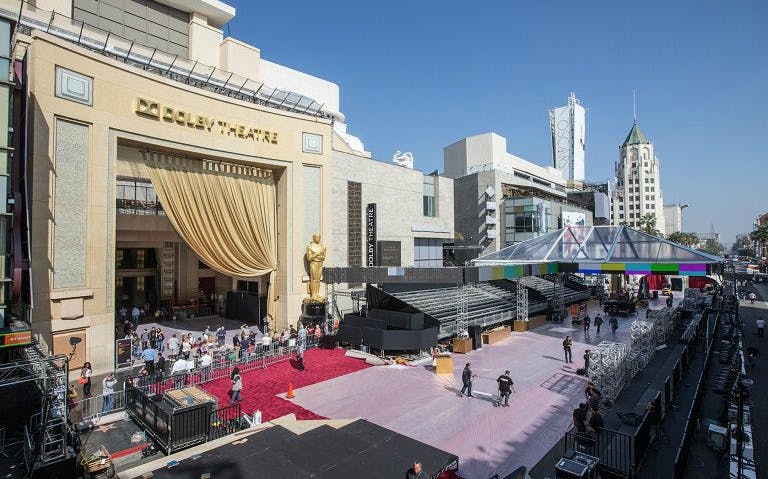 Dolly Theatre in Hollywood with Oscar statue and red carpet setup.