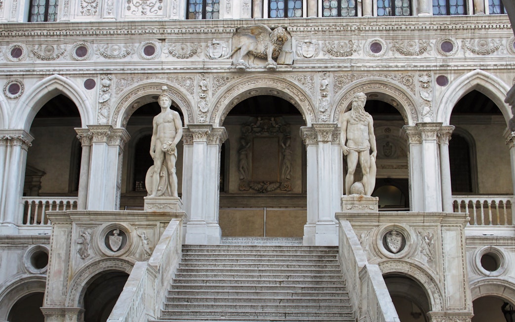 Doge's Palace staircase with statues in Venice, Italy.