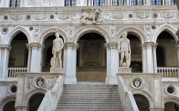 Doge's Palace staircase with statues in Venice, Italy.