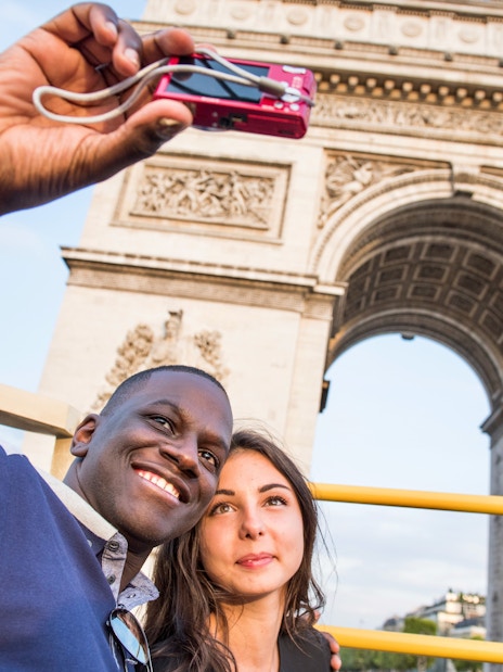 Tourists enjoying the Big Bus Paris Hop-On Hop-Off Bus Tour with a view of the Eiffel Tower and Seine River in the background