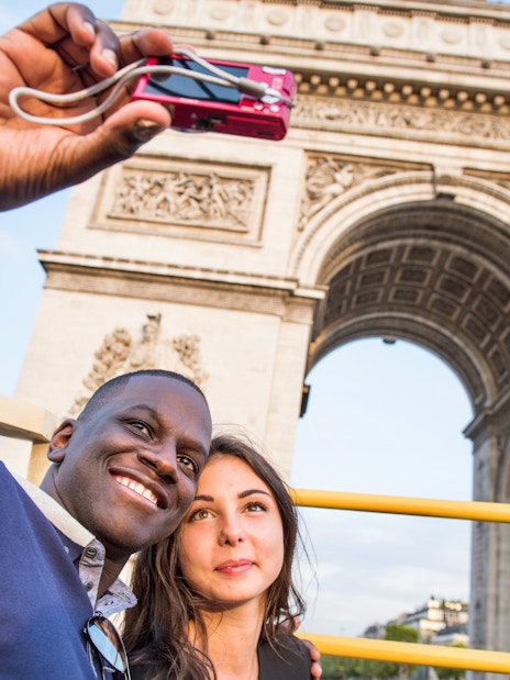 Tourists enjoying the Big Bus Paris Hop-On Hop-Off Bus Tour with a view of the Eiffel Tower and Seine River in the background