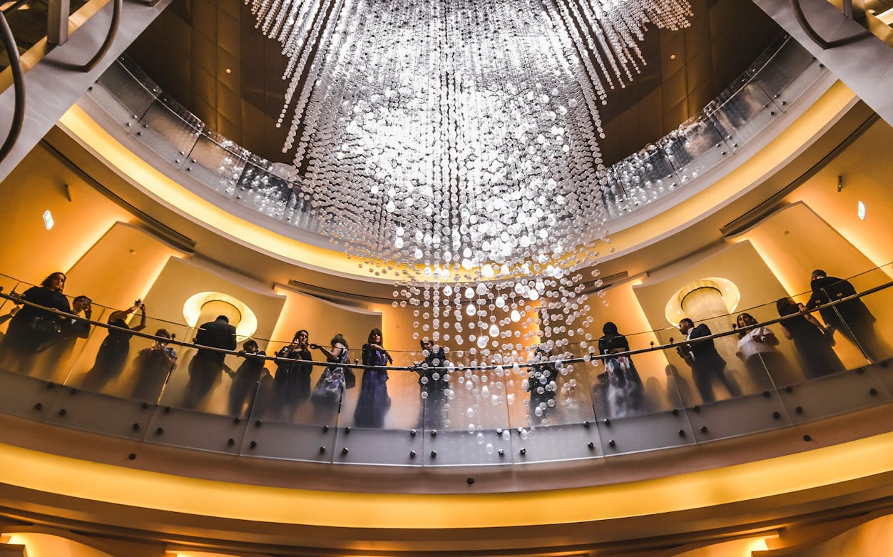 Visitors admire the grand chandelier inside Dubai Opera House.