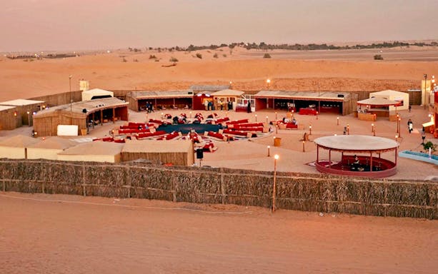 Desert camp setup for sunset camel trek with BBQ dinner experience.