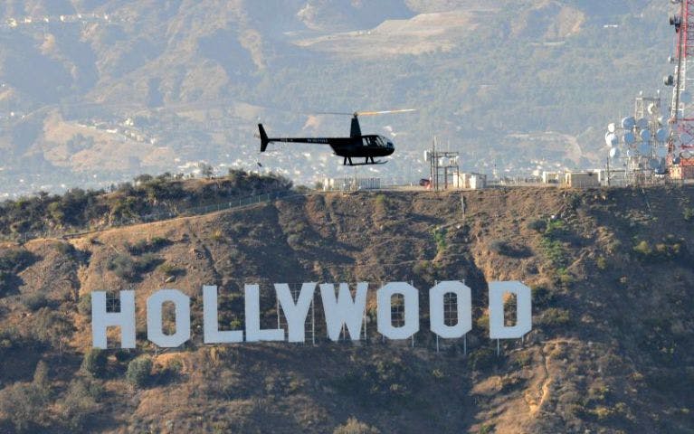 Helicopter flying over the Hollywood Sign in Los Angeles.