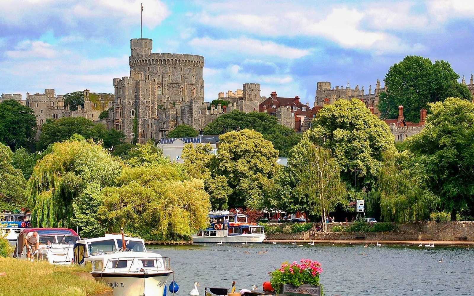 Windsor Castle view with boats on the River Thames, part of a guided tour from London.