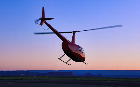 Helicopter taking off at sunset for a couple's private 45-minute tour.