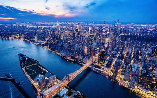 Aerial view of New York City skyline at dusk during a helicopter tour.