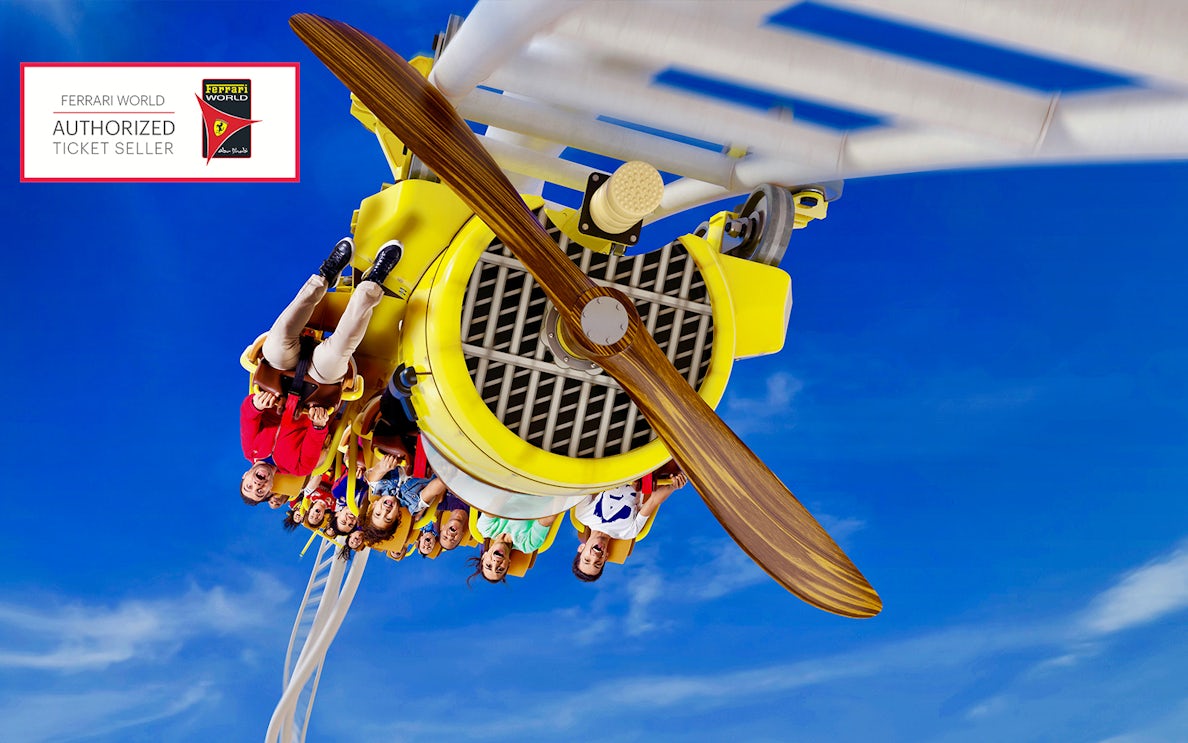 Visitors on a roller coaster at Ferrari World Abu Dhabi with a free meal voucher offer.