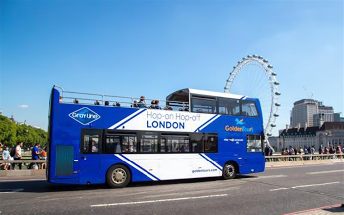 Open-top London tour bus near the London Eye.