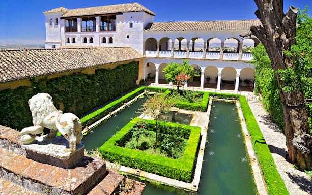 Alhambra's Generalife gardens with fountains and hedges, Granada, Spain.