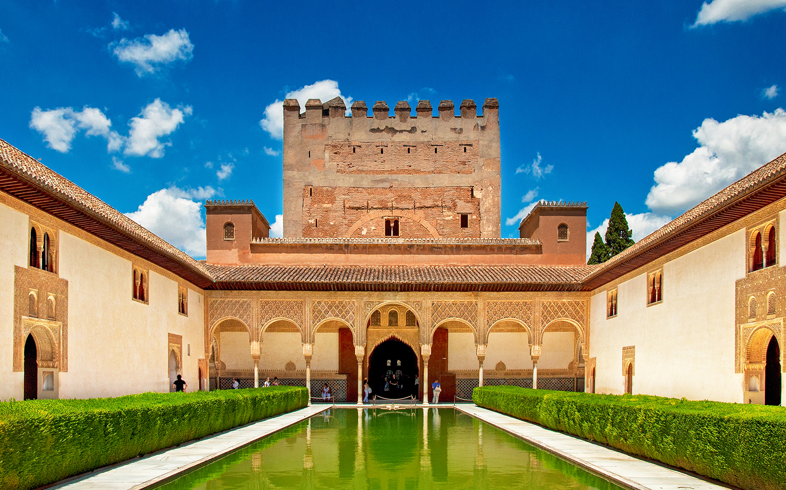 Alhambra's courtyard with reflecting pool and Moorish architecture, Granada, Spain.