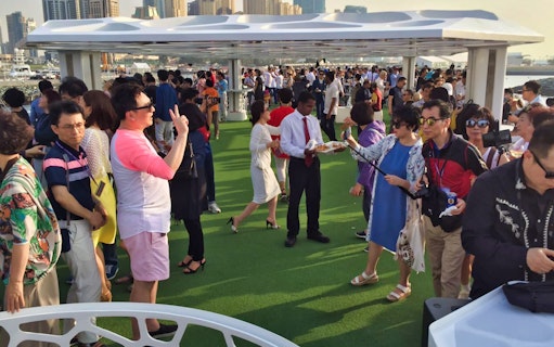Guests enjoying a brunch on the deck of the Lotus Mega Yacht during a weekend cruise.