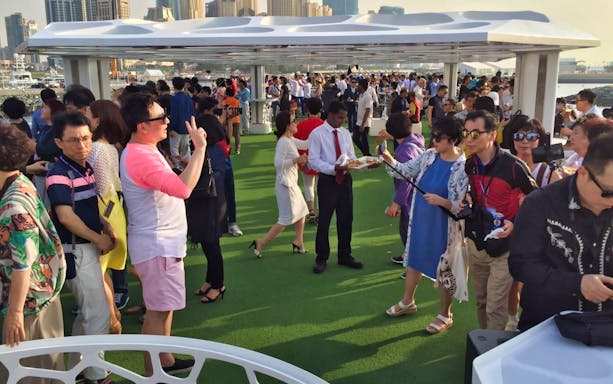 Guests enjoying a brunch on the deck of the Lotus Mega Yacht during a weekend cruise.