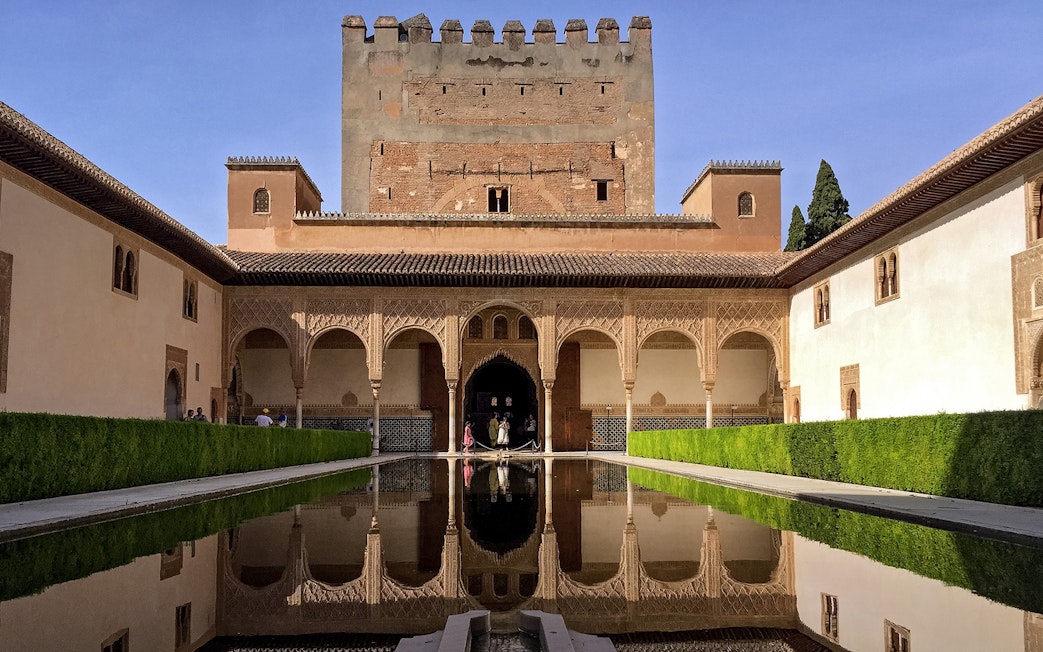 Alhambra Palace courtyard with reflecting pool, Granada, Spain.