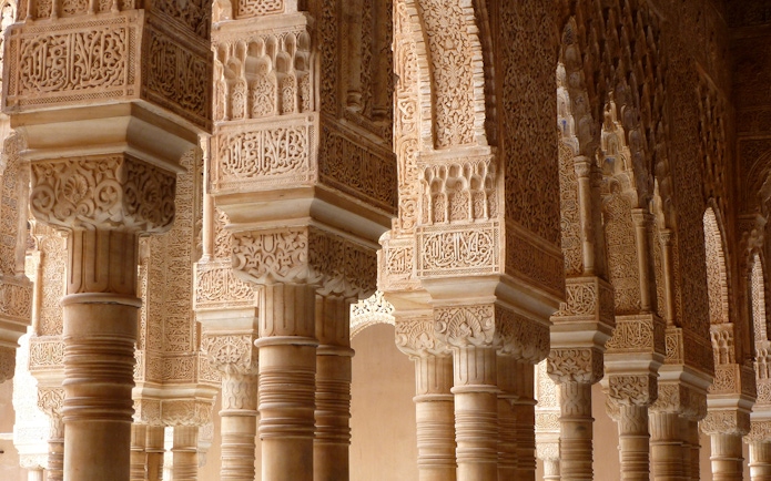 Alhambra Palace intricate stone arches and columns detail, Granada, Spain.