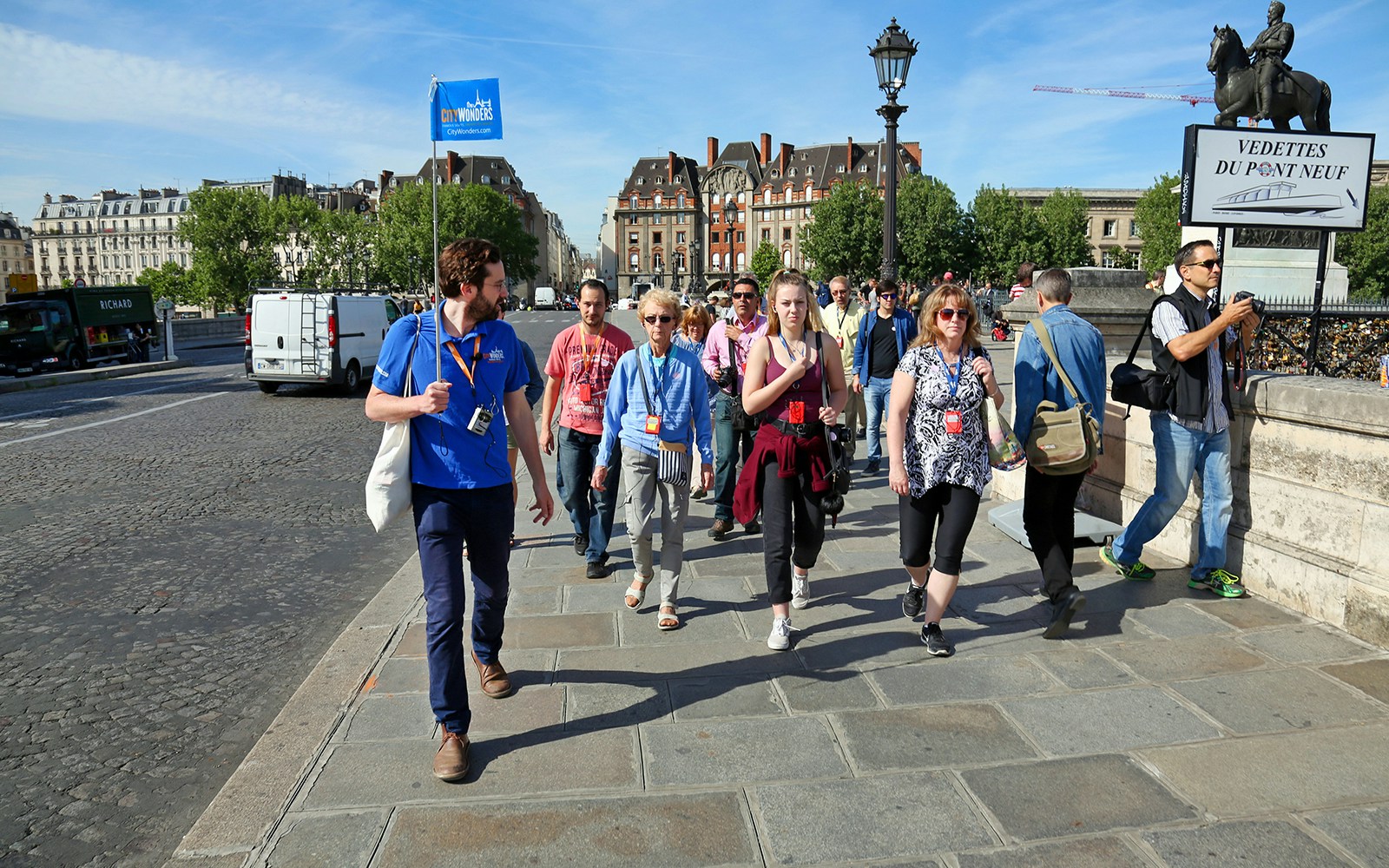 Tour group walking on Île de la Cité during Notre Dame Tour, Paris.
