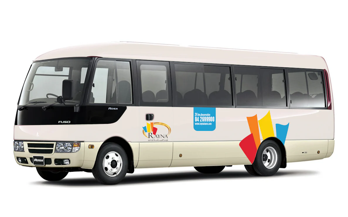 Shuttle bus for airport pick-up from Terminal 1/3 with Rayna Tours branding.