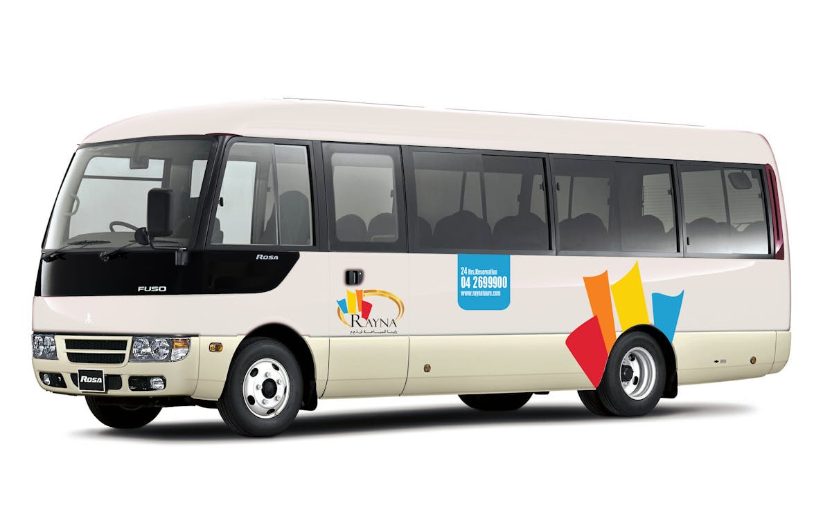 Shuttle bus for airport pick-up from Terminal 1/3 with Rayna Tours branding.