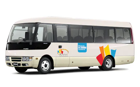 Shuttle bus for airport pick-up from Terminal 1/3 with Rayna Tours branding.