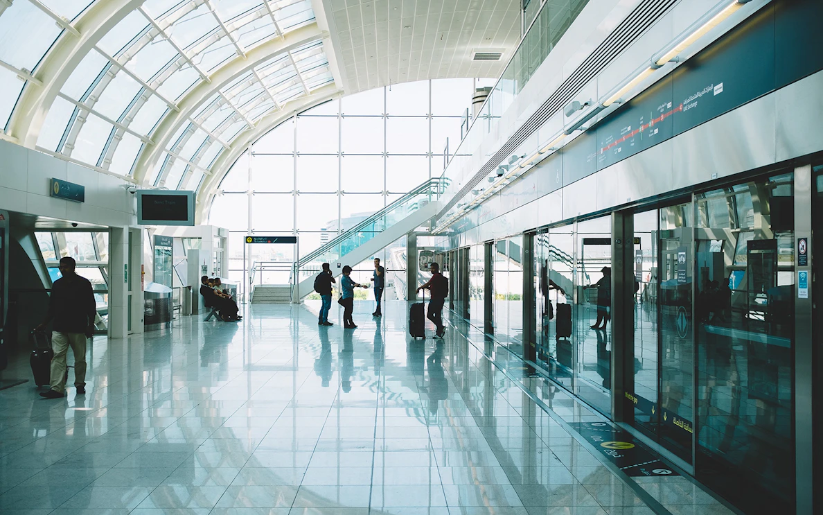 Passengers waiting in a modern airport terminal for private transfers.