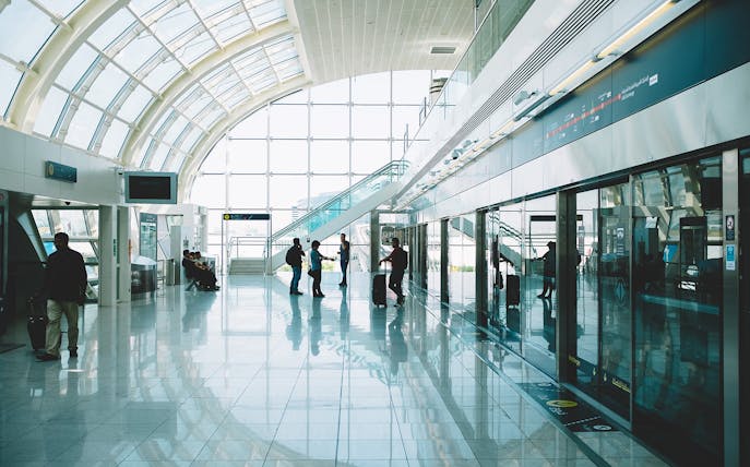 Passengers waiting in a modern airport terminal for private transfers.